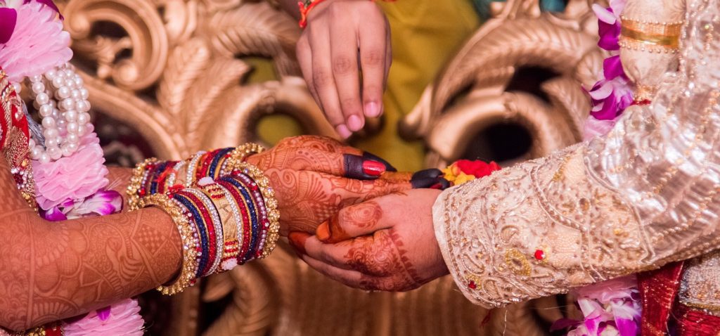 Indian wedding hand holding bride groom