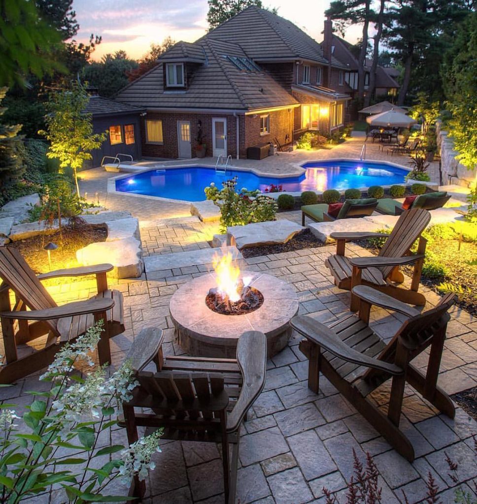 Outdoor garden seating by the pool with fire place